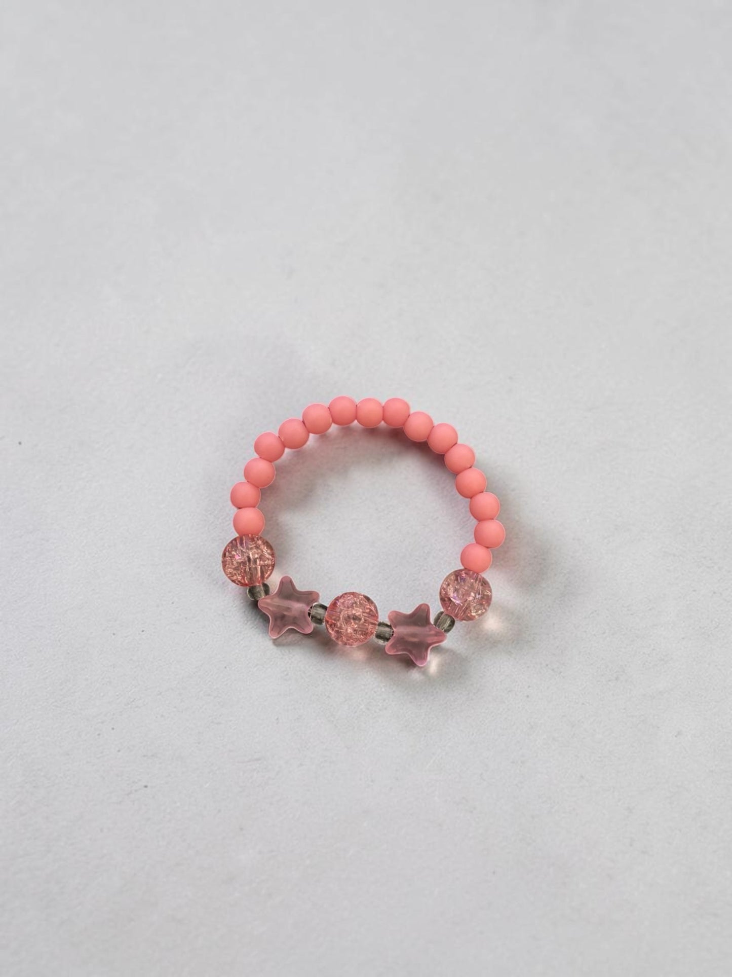 Bracelet enfant petites étoiles rose foncé craquelé