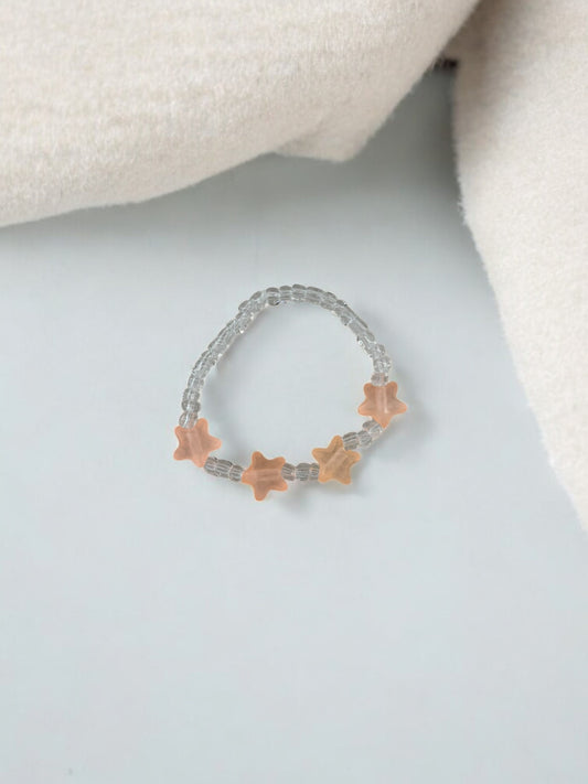Bracelet enfant petites étoiles rose saumon transparent