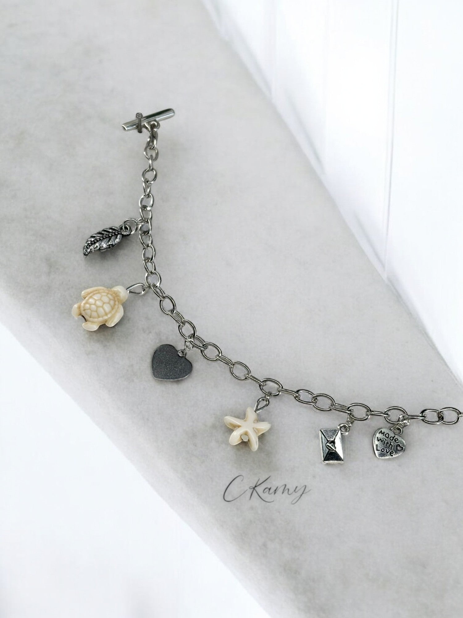 Bracelet femme chaîne tortue étoile de mer blanc et feuille