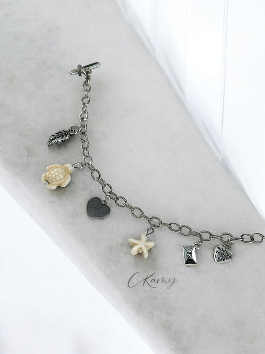 Bracelet femme chaîne tortue étoile de mer blanc et feuille