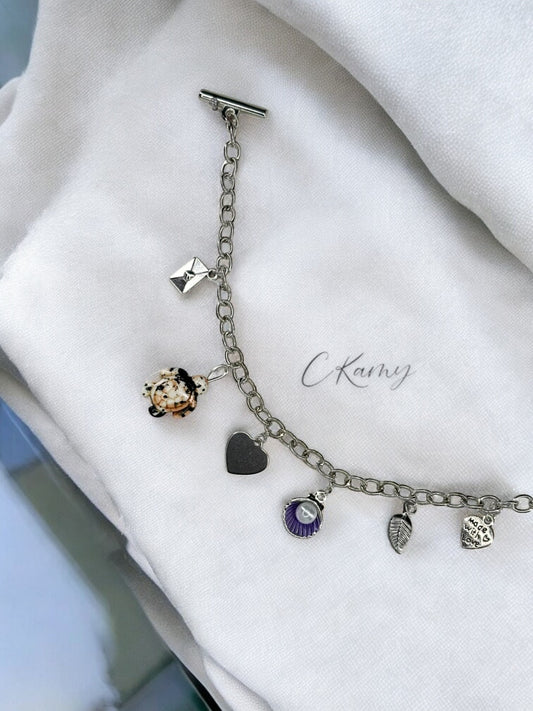 Bracelet femme chaîne tortue noir noix de saint jacques violet