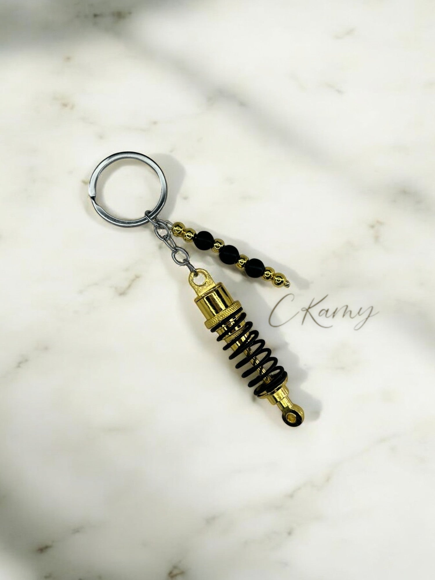 Porte clé personnalisé amortisseur doré